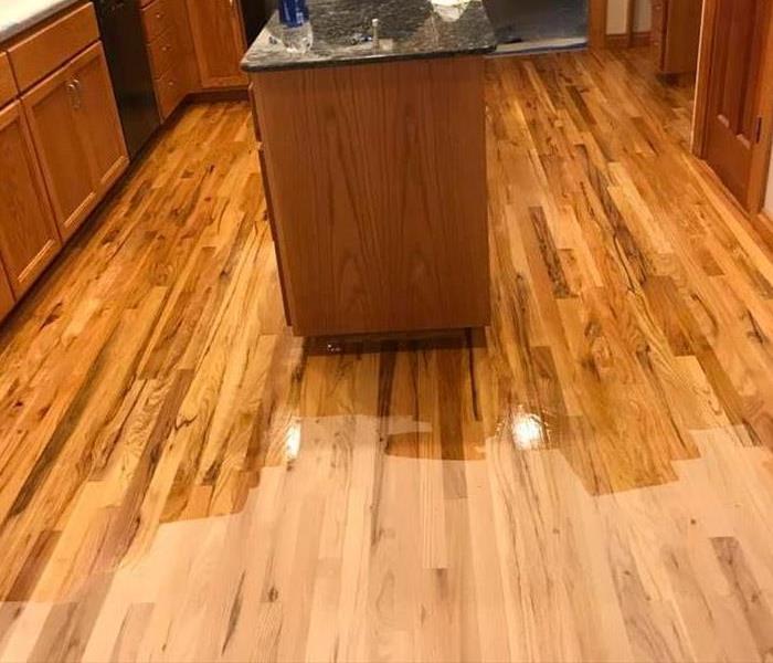 Wood floors that had to be sanded down and restained after a water loss in the kitchen.